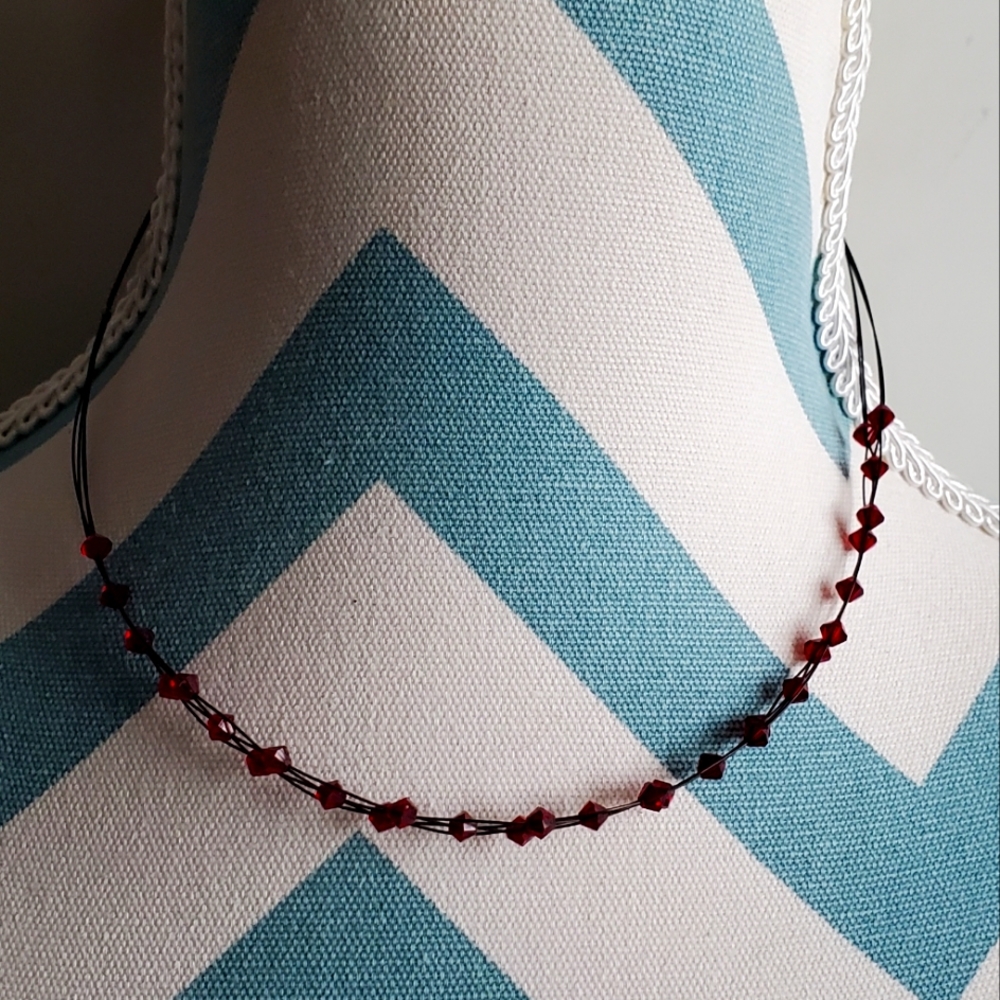 Choker length ruby toned necklace with earrings.